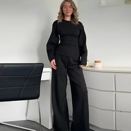 Women's black fleece tracksuit set featuring a pleated long sleeve top and wide leg trousers