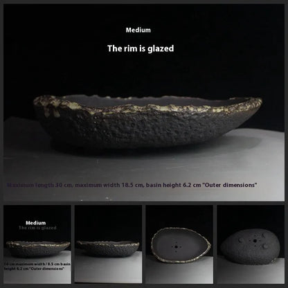 Handmade purple clay flower pot with unique shape showing natural ceramic texture