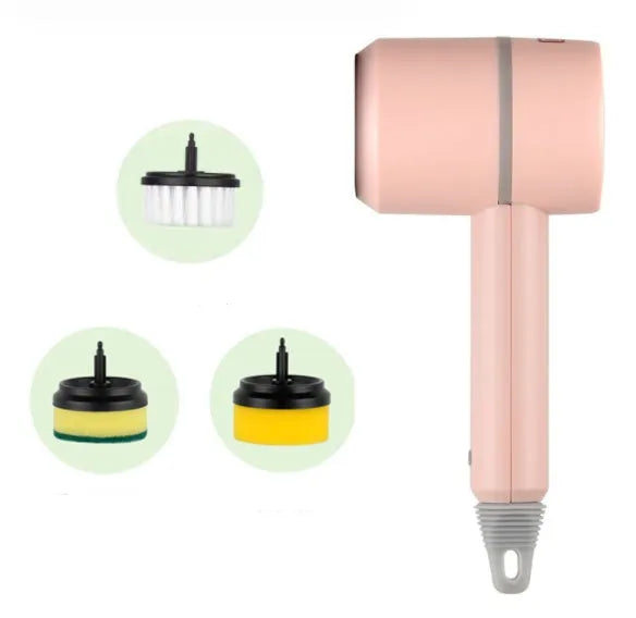 Green electric cleaning brush with scouring pad and brush heads on a kitchen worktop.