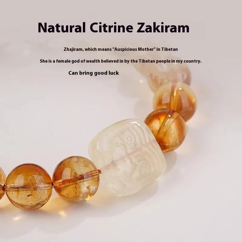 Close-up of a women's carved citrine bracelet with geometric patterns on 10mm crystal beads.