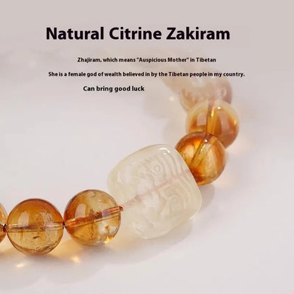 Close-up of a women's carved citrine bracelet with geometric patterns on 10mm crystal beads.