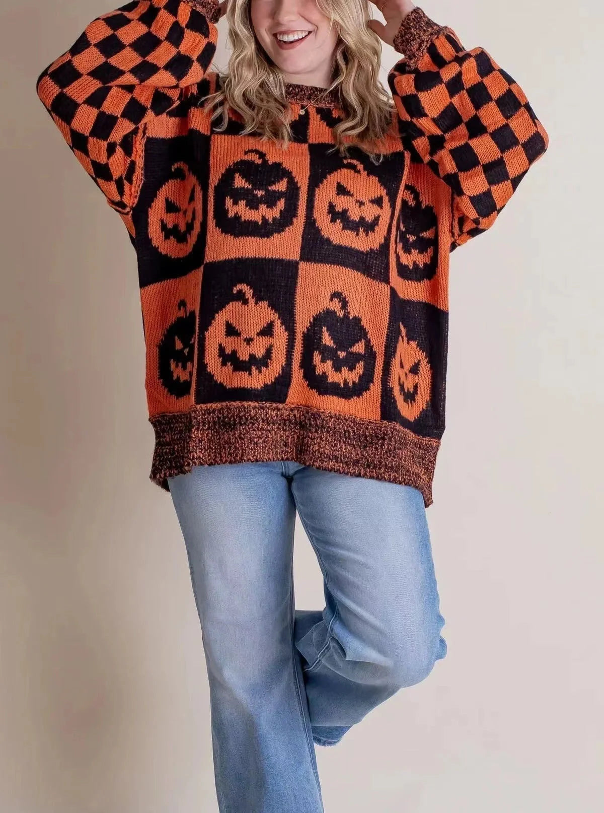 A stylish Halloween sweater featuring a unique pumpkin and ghost graphic design, available in a variety of fashion-forward colors.