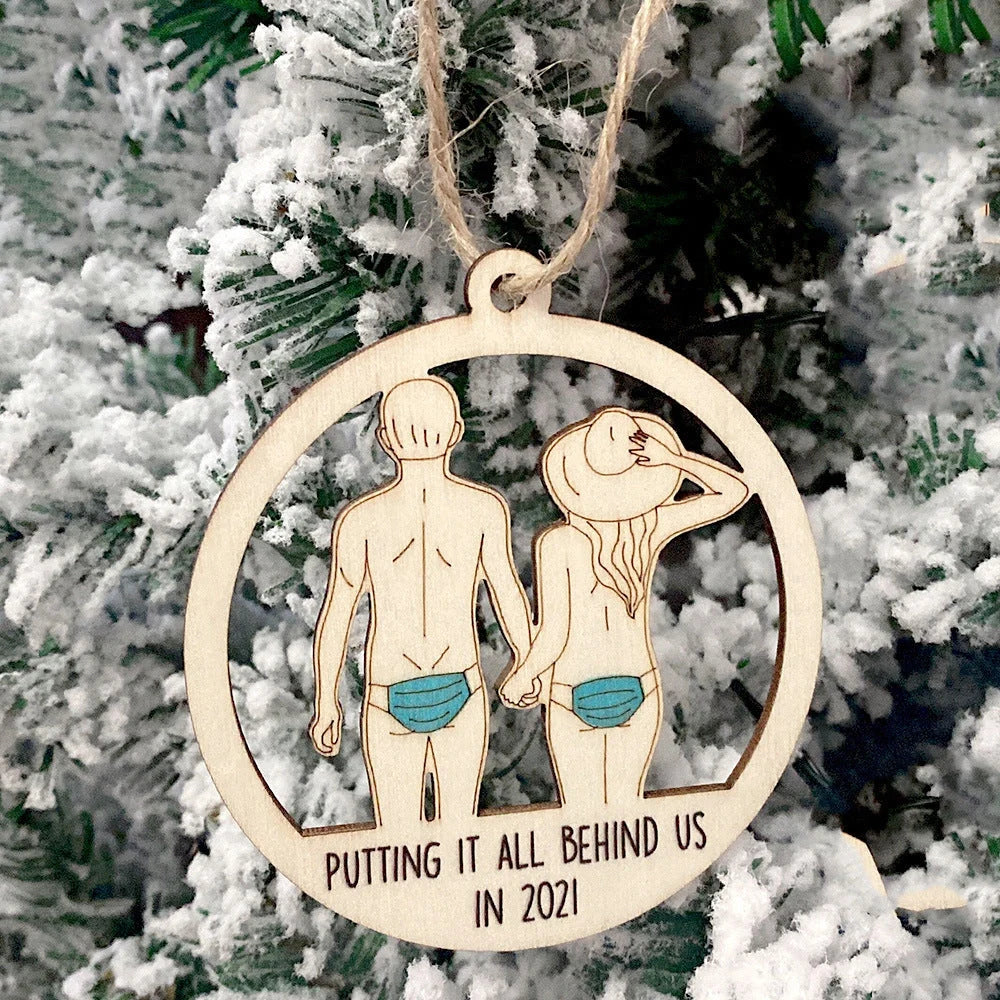 Wooden hollowed-out Christmas ornament with intricate snowman and deer laser-cut design