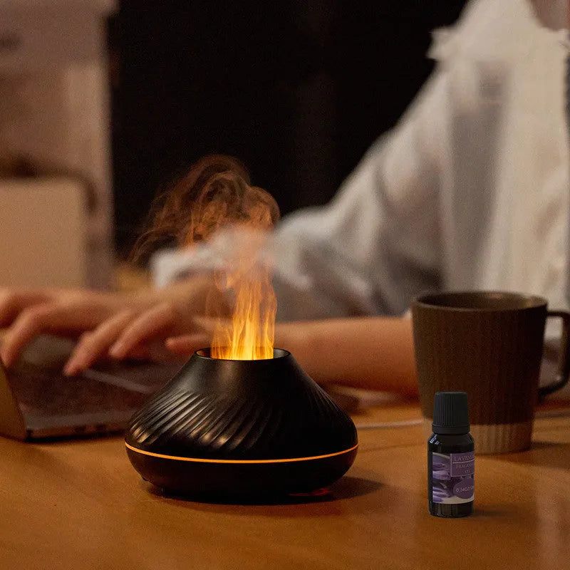 Beige volcanic flame aroma diffuser with LED lighting and mist output on wooden surface