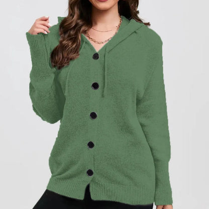 A woman wearing a loose, thick, hooded cotton cardigan in a solid colour.