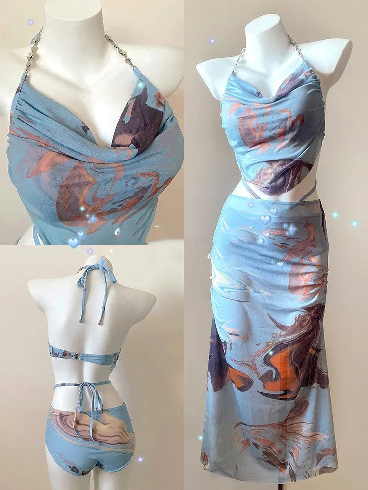 Women's blue print bikini set with triangle top, pants, and skirt, showing steel support structure.