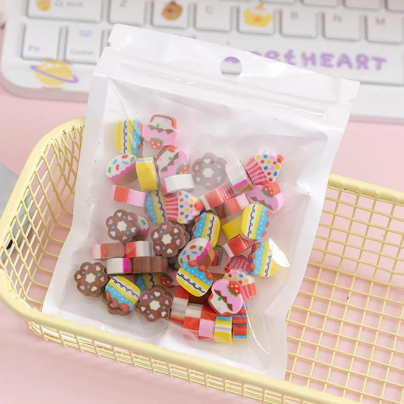 Assortment of 50 small cartoon erasers in pearlescent bags, showing fruit, animal, and holiday designs.