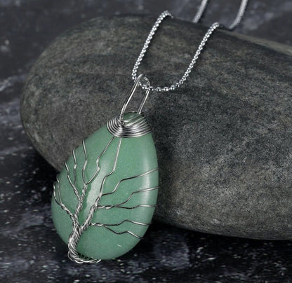 A Celtic Tree of Life pendant necklace made with a teardrop-shaped semi-precious stone and an adjustable chain.