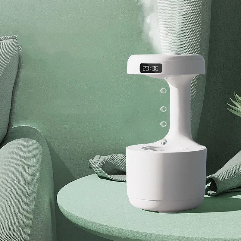 White columnar anti-gravity humidifier with LED clock display on a wooden desk