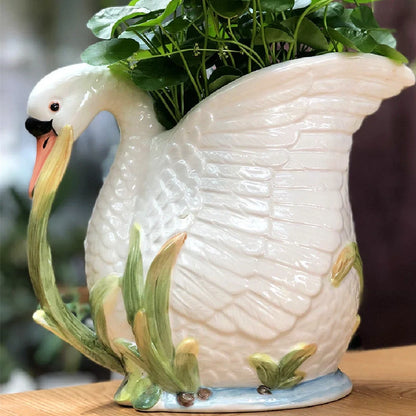 Ceramic vase with embossed swan design measuring 24.1cm length 15.2cm width 20cm height