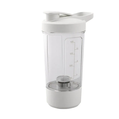 Black electric protein shaker bottle with lid and USB charging cable on a table