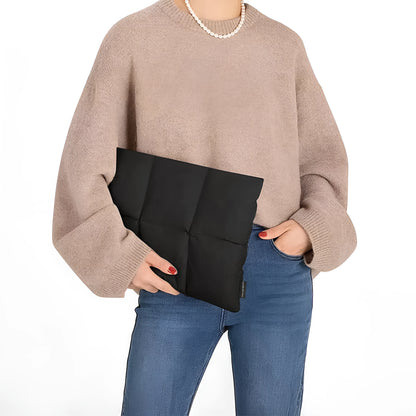 Soft black polyester laptop sleeve for a 15.6-inch laptop on a table.