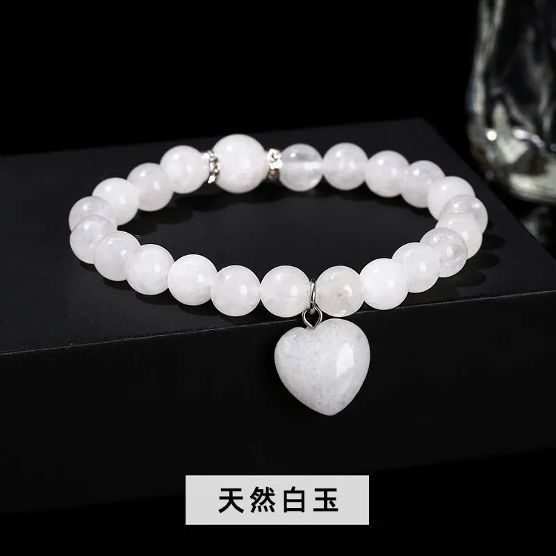Handmade women's bracelet with natural gemstone beads and a silver love pendant charm.
