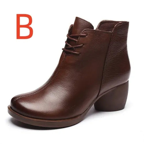 Women's brown leather retro Martin boots with a thick block heel and round toe on a wooden floor.