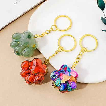 Natural crystal cat's paw keychain pendant showing gemstone options with integrated attachment loop