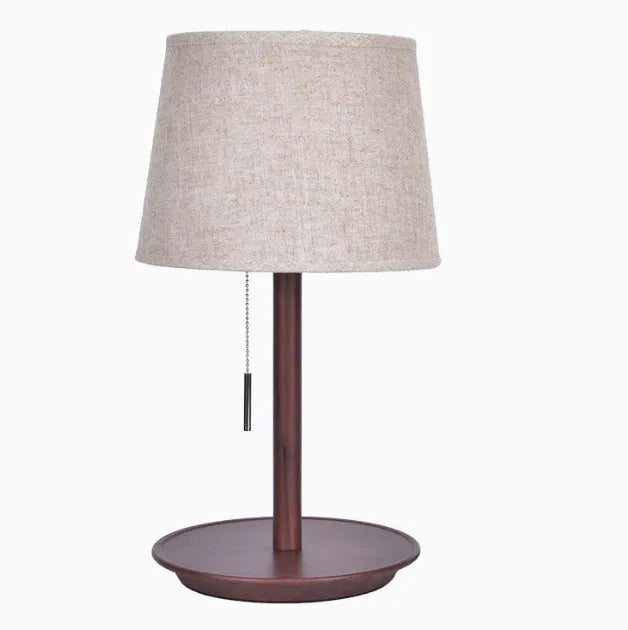 Walnut solid wood bedside lamp with fabric lampshade on wooden surface