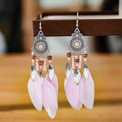 Bohemian feather leaf pattern alloy earrings in round drop shape on a colour selection background.