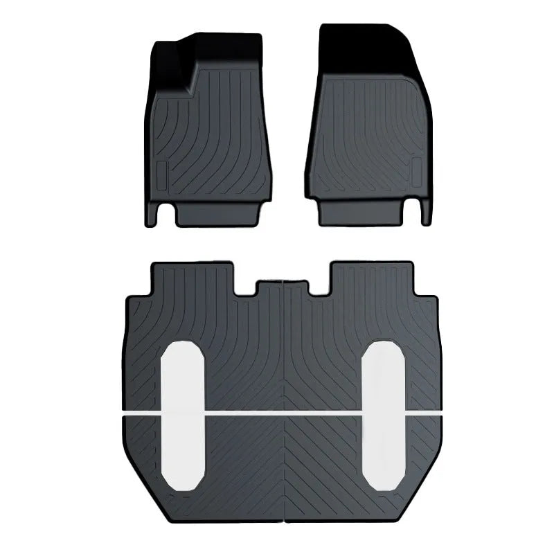 Black TPE rubber floor mats for Tesla Model 3, showing deep grooves and raised edges on driver's side.