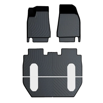Black TPE rubber floor mats for Tesla Model 3, showing deep grooves and raised edges on driver's side.