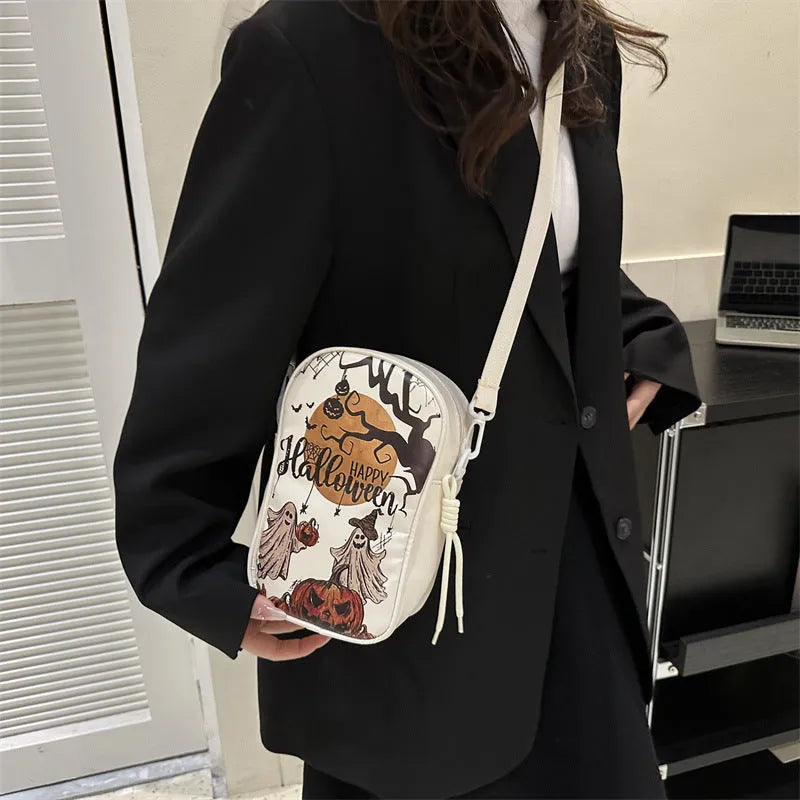 Halloween graffiti print crossbody bag in black with pumpkin, ghost, and bat designs, measuring 14x23x9.5cm