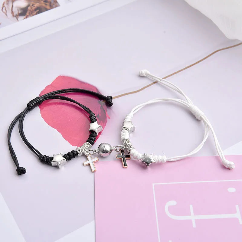 Magnetic suction couple bracelet pair in alloy with an electroplated finish, showing example designs like a crown and love lock.