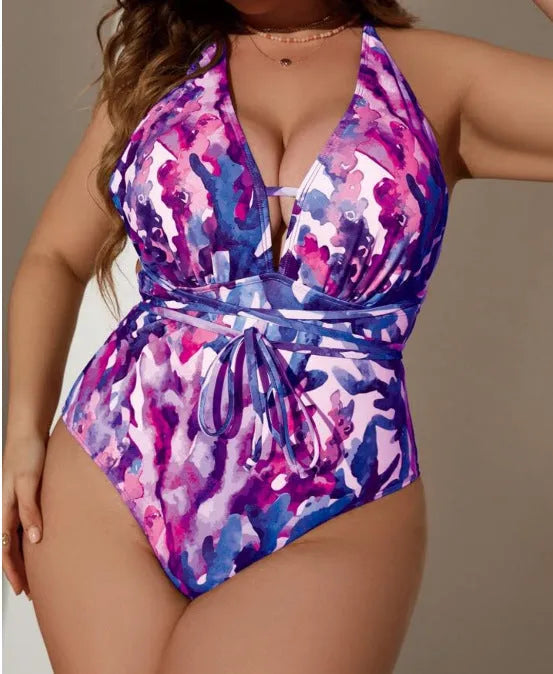 Purple solid colour one-piece halter swimsuit with adjustable neck ties on a mannequin, showing brief style bottom.