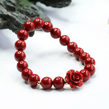 Close-up of a handmade purple gold sand cinnabar rose bracelet with an 8mm bead.