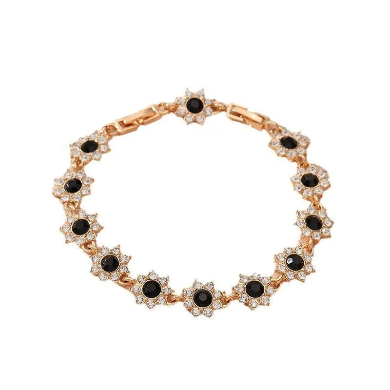Floral shaped zinc alloy bracelet with electroplated colourful gem finishes in gold and silver tones.