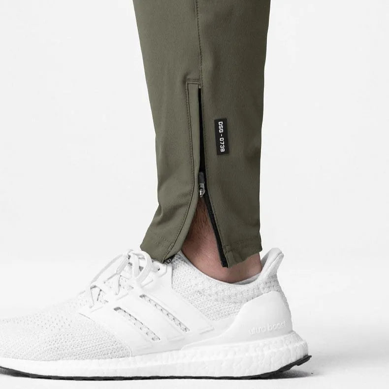 Men's grey fitness trousers with ankle ties, made from quick-drying polyester, for exercise and casual use.