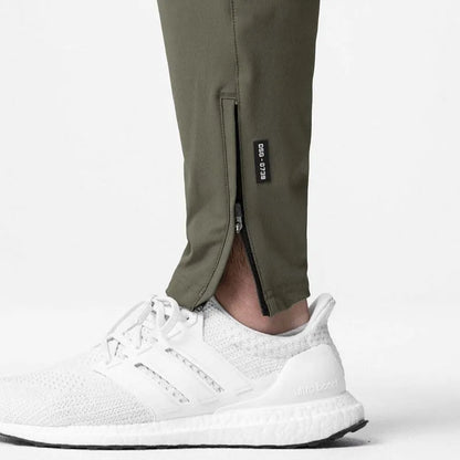 Men's grey fitness trousers with ankle ties, made from quick-drying polyester, for exercise and casual use.