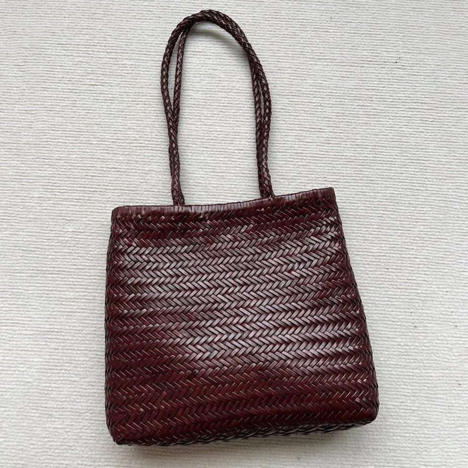 Brown handmade woven leather tote bag with three-dimensional pocket, showing 27cm height and textured cowhide construction