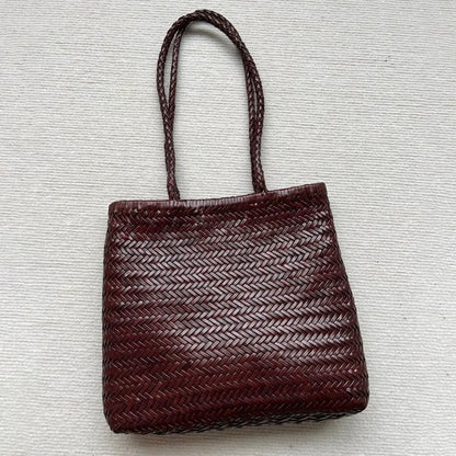 Brown woven cowhide leather tote bag with three-dimensional pocket, shown with dimensions 27cm by 30cm