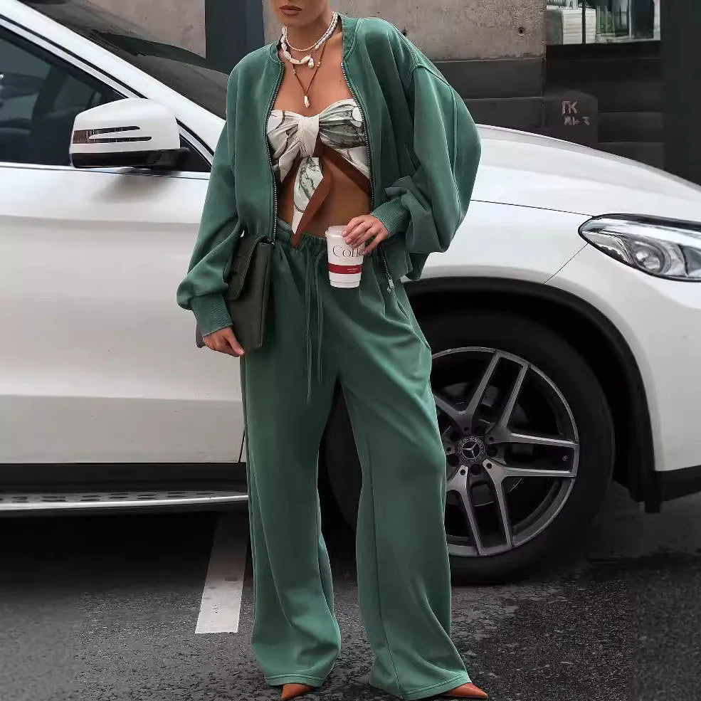 Green women's thermal sweater with front zipper and stand collar, paired with matching trousers