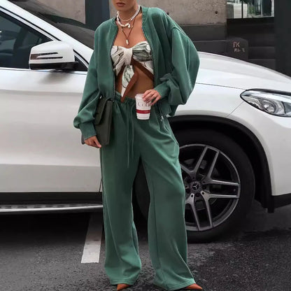 Green women's thermal sweater with front zipper and stand collar, paired with matching trousers