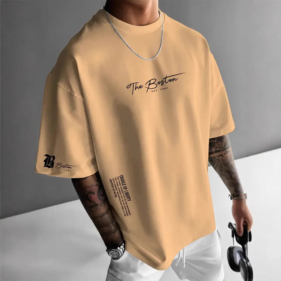 Men's round neck loose letter short sleeve T-shirt in polyester, shown in white, black, coral, and apricot