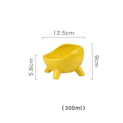 Green ceramic cat food bowl with four legs and elevated design for stable feeding