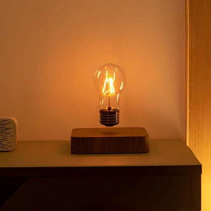 Self-rotating maglev LED bulb levitating above circular base with warm yellow illumination