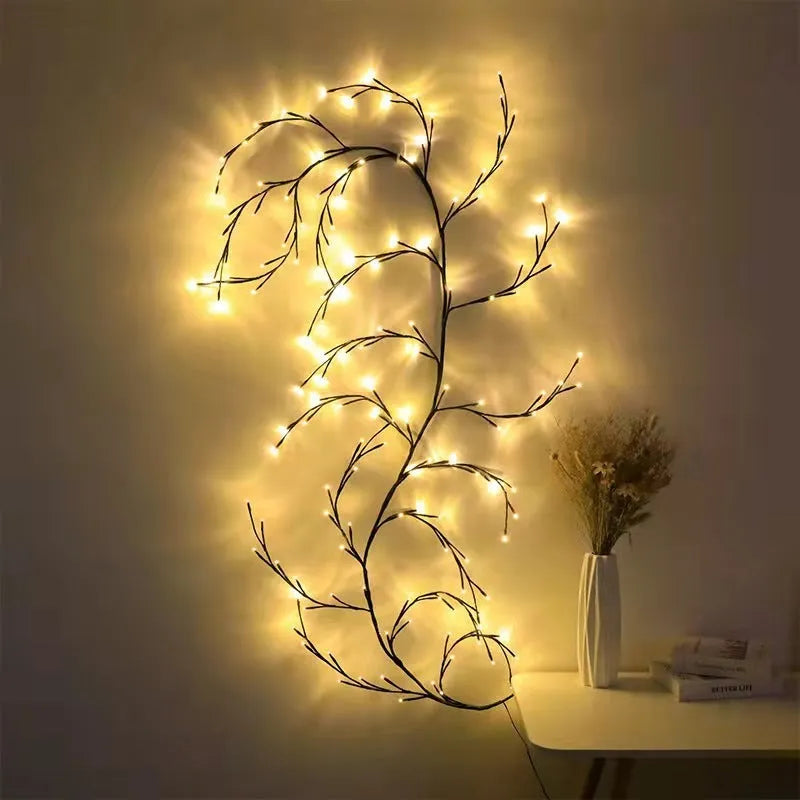 Flexible DIY willow vine LED light garland with warm white lights shaped on a wall.