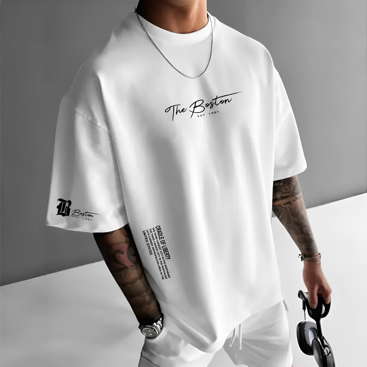 Men's round neck loose letter short sleeve T-shirt in polyester, shown in white, black, coral, and apricot