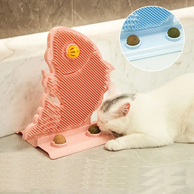 Blue fish-shaped cat wall scratcher with grooming brush, two catnip balls, and bell on white base