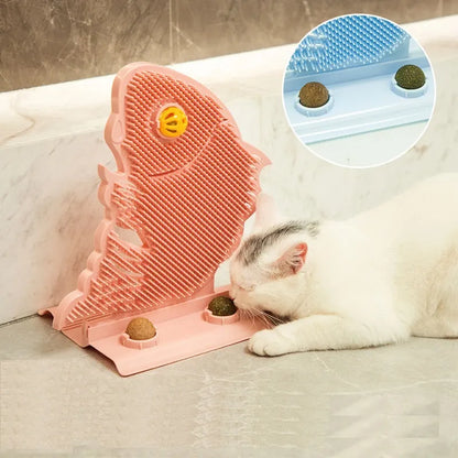Blue fish-shaped cat wall scratcher with grooming brush, two catnip balls, and bell on white base
