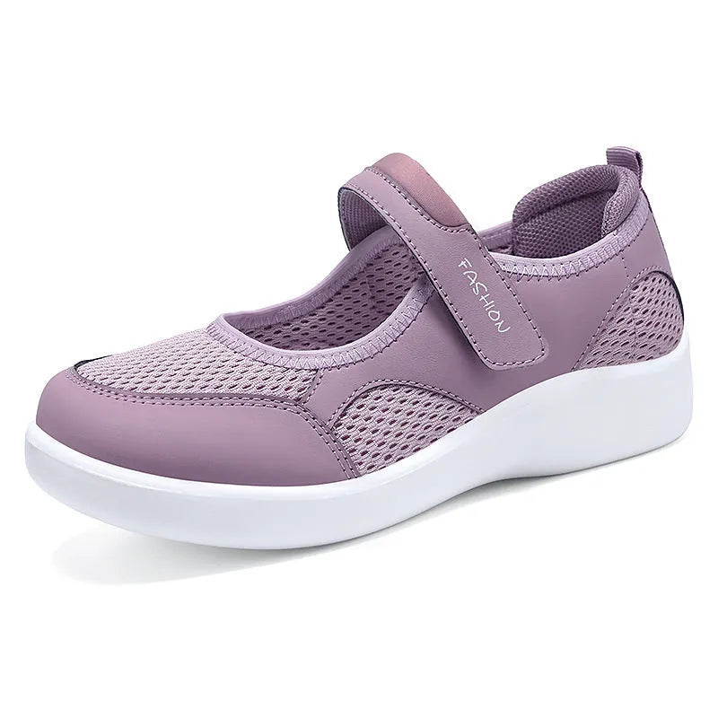 Women's grey velcro casual shoes with mesh upper and flat sole.