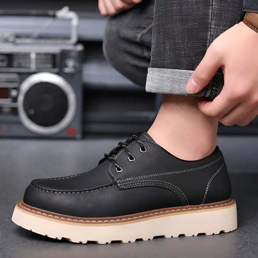 Men's black low-top Martin boots with a round toe and rubber sole on a white background.