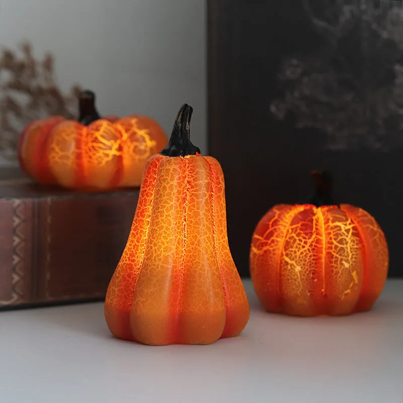 Set of three resin Halloween pumpkin lanterns with LED lights in long, medium, and short sizes.