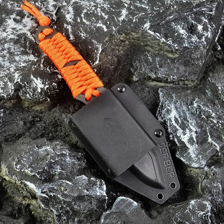Outdoor survival knife with straight blade, rope-bound handle, and black ABS sheath on grey background