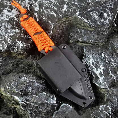 Outdoor survival knife with straight blade, rope-bound handle, and black ABS sheath on grey background