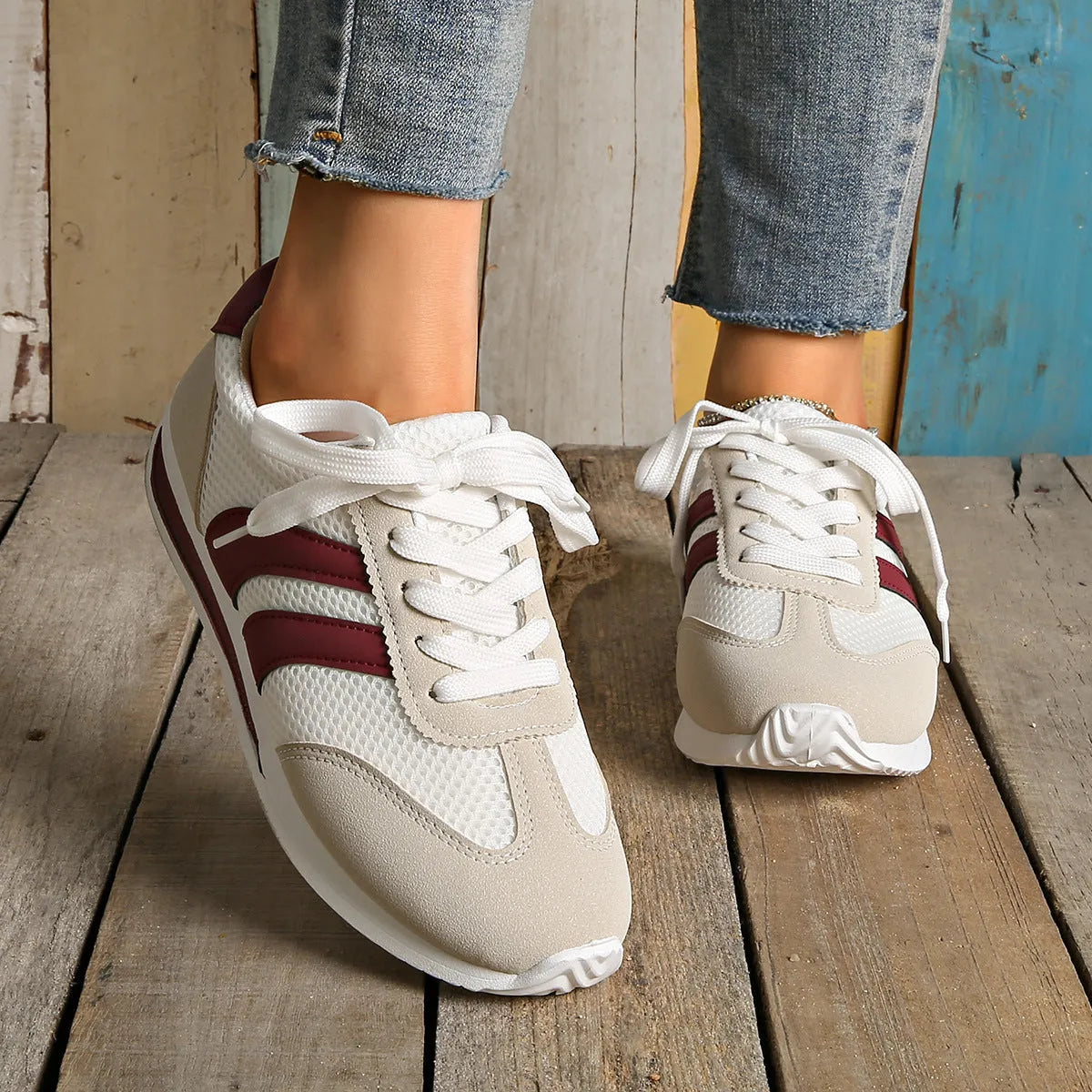 Wine red retro sneakers with cross-strap detail and breathable mesh surface