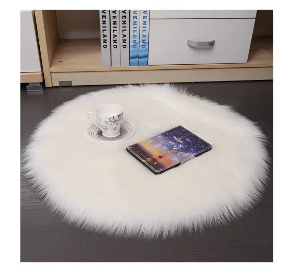 Round plush wool carpet in beige colour on a wooden floor.
