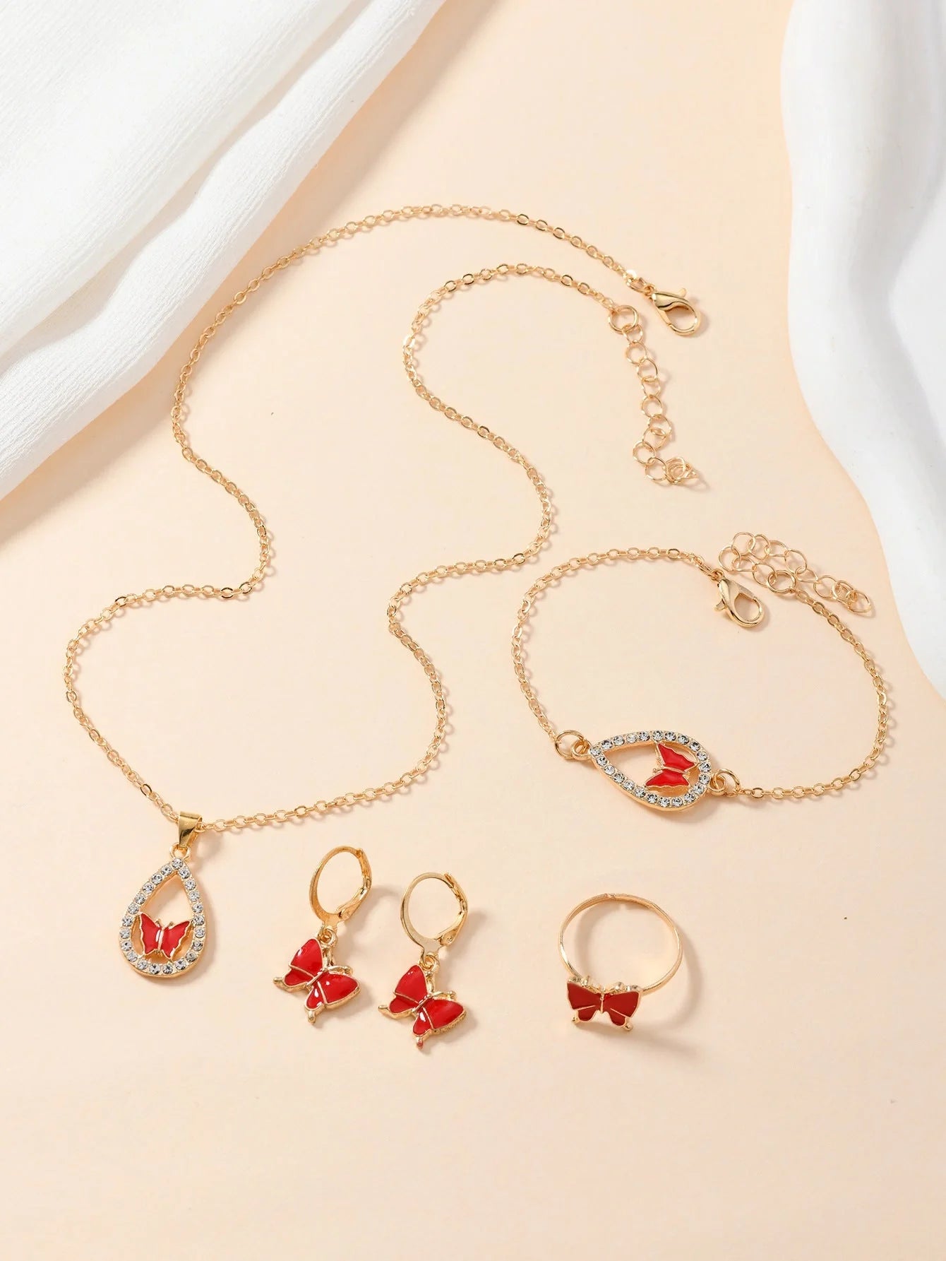 Elegant butterfly jewelry set including necklace, bracelet, and earrings with intricate design in various color options