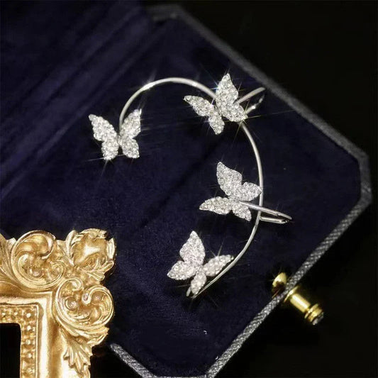 Fashionable butterfly-shaped ear clips in gold and silver tones, showcasing a chic, European-inspired design.